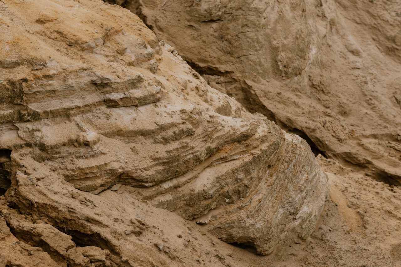 Detailed view of textured desert rock showcasing erosion patterns and layers.